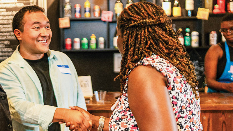 A man and woman shaking hands together